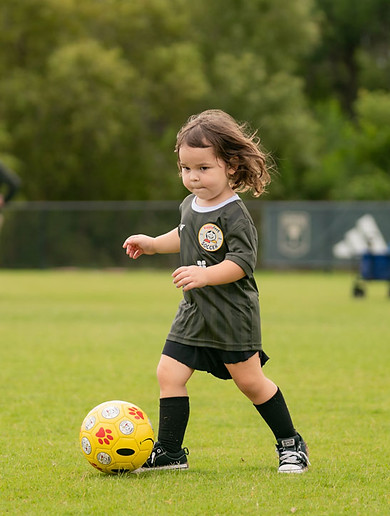 A three-year-old HappyFeet player dribbling