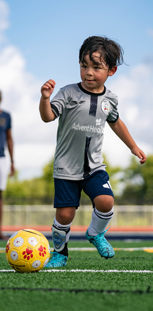 A young HappyFeet league player with the ball